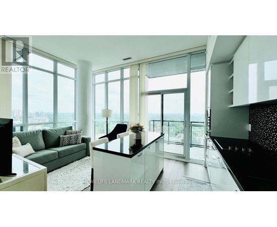 A modern living room with a glass table and a couch.