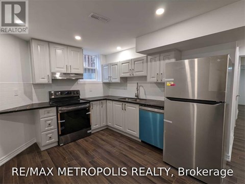 A modern kitchen with stainless steel appliances and white cabinets.