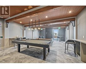 A pool table is in the middle of the room.