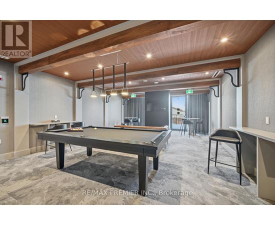 A pool table is in the middle of the room.