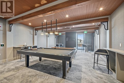 A pool table is in the middle of the room.