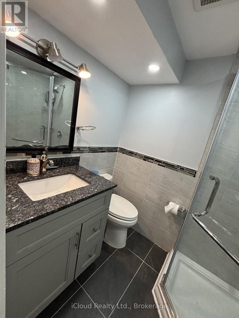 A bathroom with a sink, toilet, and shower.