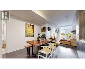 A dining room with a wooden table and chairs.