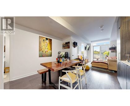 A dining room with a wooden table and chairs.