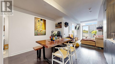 A dining room with a wooden table and chairs.