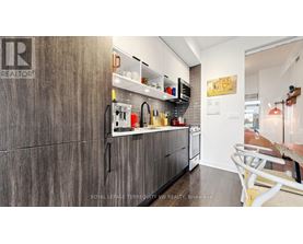 A kitchen with a wooden cabinet and a white counter.