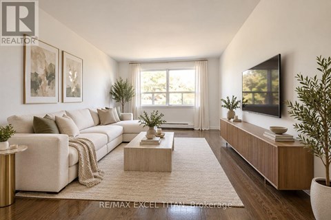 A modern living room with a white sofa, a wooden coffee table, and a flat-screen TV mounted on the wall.