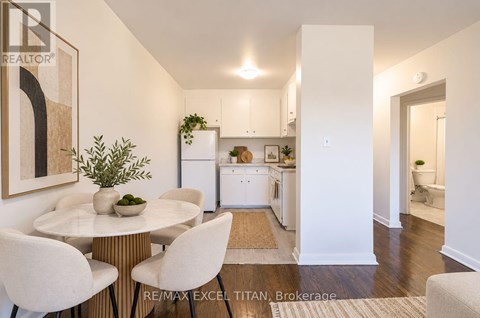 A dining room with a white table and chairs.