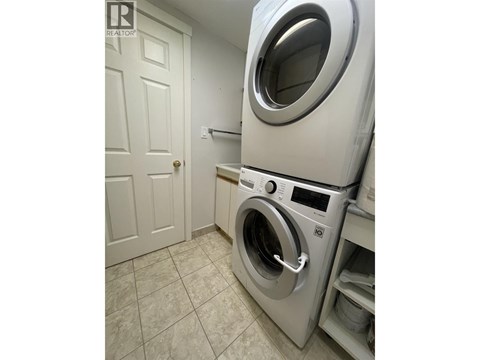A washing machine in a laundry room.