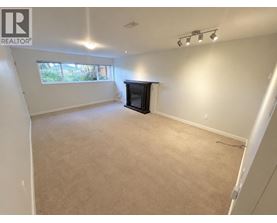 A living room with a fireplace and a window.