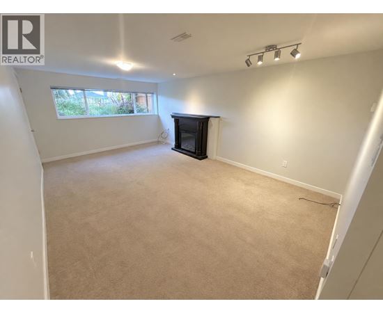 A living room with a fireplace and a window.