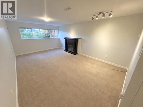 A living room with a fireplace and a window.