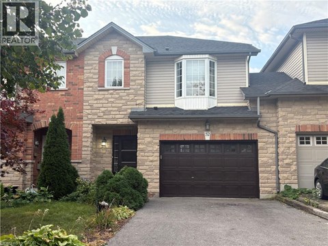 A house with a garage and a driveway in front.