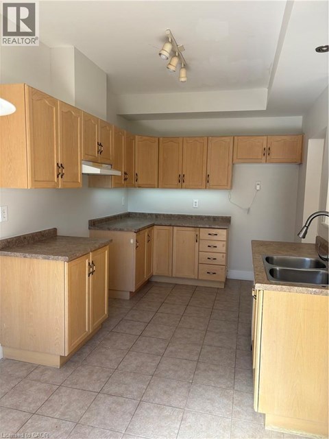 A kitchen with wooden cabinets and a sink.