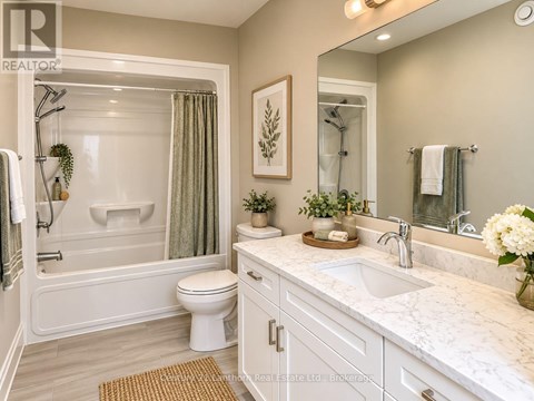 A white bathroom with a marble counter top and a white toilet.