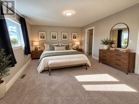 A well-lit bedroom with a large bed, a bench, and a mirror.