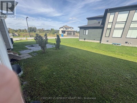 A well-maintained lawn in front of a modern house.