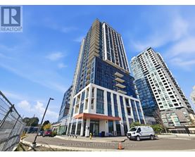 A tall building with a glass facade is the main focus of the image.