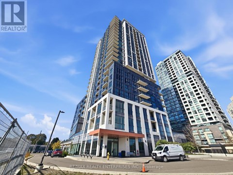 A tall building with a glass facade is the main focus of the image.