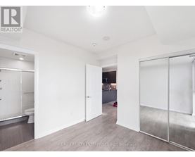 A white room with a glass door leading to another room.