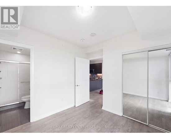 A white room with a glass door leading to another room.