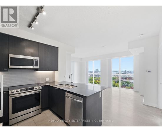 A modern kitchen with a stainless steel dishwasher and oven.