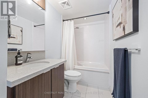 A bathroom with a white toilet, a white sink, and a white bathtub.