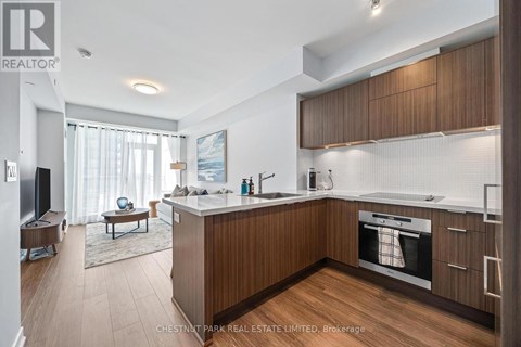 A modern kitchen with wooden cabinets and a central island.