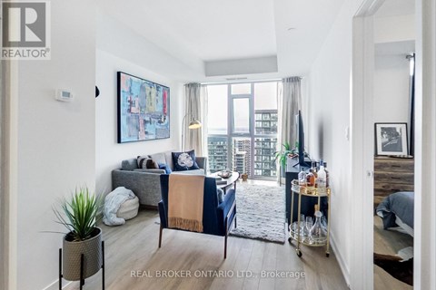 A living room with a grey couch and a blue and beige sofa.