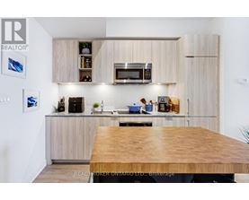 A modern kitchen with wooden cabinets and a wooden table.