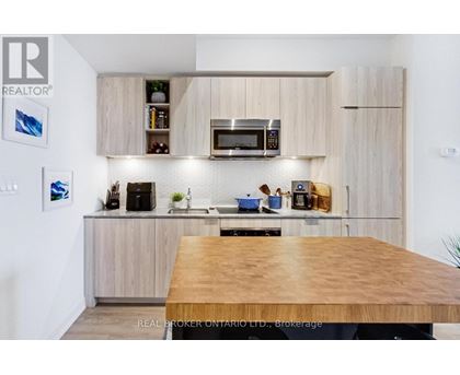 A modern kitchen with wooden cabinets and a wooden table.