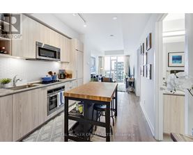A modern kitchen with wooden cabinets and a central island.