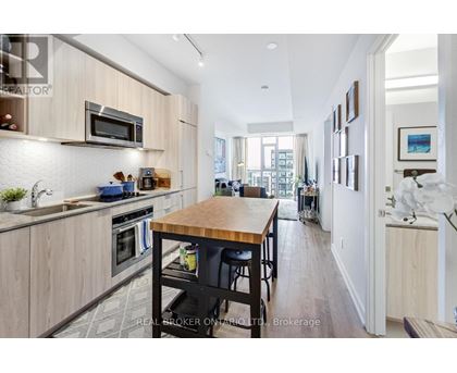 A modern kitchen with wooden cabinets and a central island.