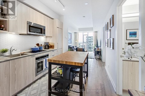 A modern kitchen with wooden cabinets and a central island.