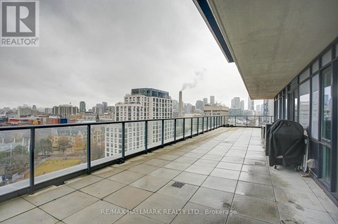 A balcony with a view of a city skyline.