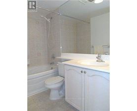 A white bathroom with a toilet, sink, and bathtub.