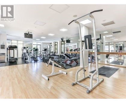 A gym with a variety of equipment including treadmills, weights, and exercise machines.