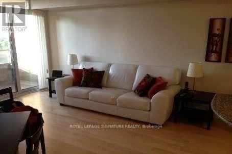A living room with a white couch and a coffee table.