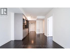 A long hallway with white walls and wood floors.