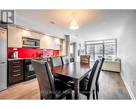 A modern kitchen with a dining table and chairs.