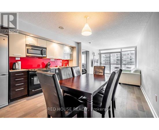 A modern kitchen with a dining table and chairs.