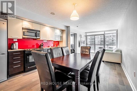 A modern kitchen with a dining table and chairs.