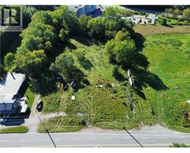 A bird's eye view of a green hill with a road running through it.