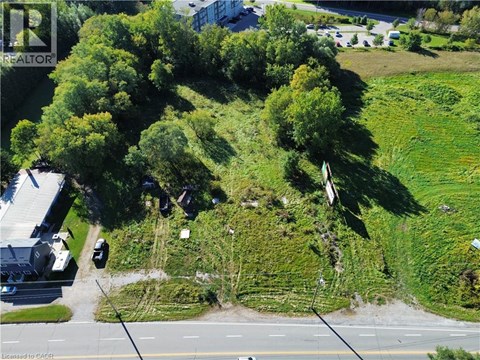 A bird's eye view of a green hill with a road running through it.