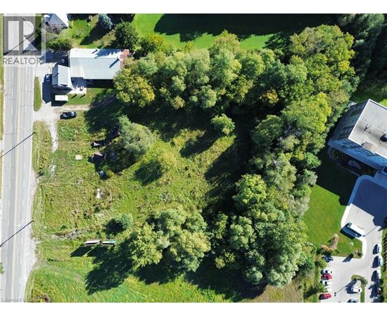 A REALTOR image of a green area with trees and buildings.