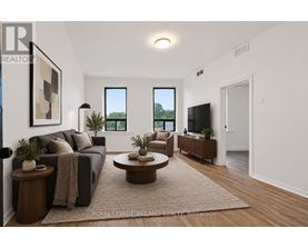 A living room with a couch, a coffee table, and a flat screen TV.
