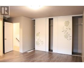A room with a white door and a wall with a flower design.