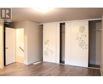 A room with a white door and a wall with a flower design.