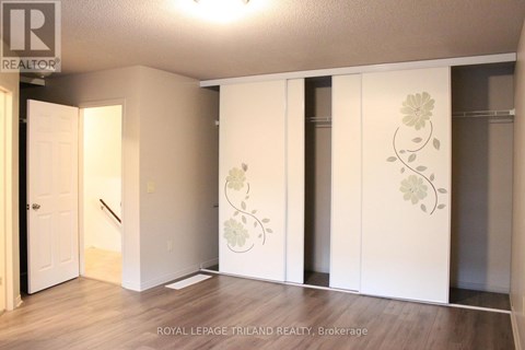 A room with a white door and a wall with a flower design.