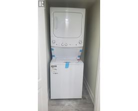 A white dishwasher is in a small space.